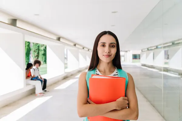Frontal portrait of a caucasian female student standing on the campus