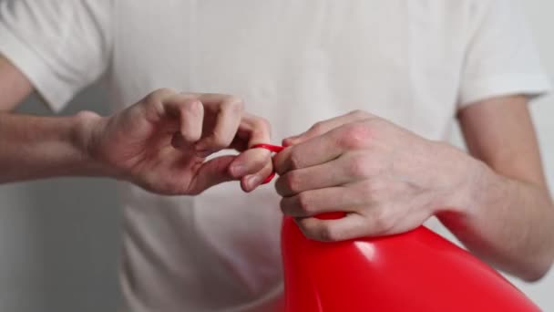 Young Caucasian Unrecognizable Man White Shirt Ties Red Balloon His — Stockvideo