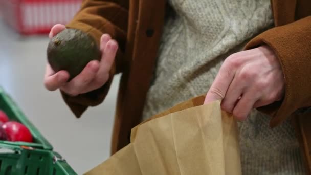 Young Caucasian Unrecognizable Man Brown Coat Knitted Sweater Takes Avocado — Stock Video
