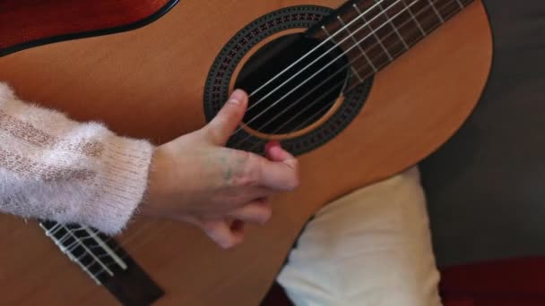 Little Caucasian Girl Unrecognizable Holding Guitar Fingering Strings Learning Notes — Vídeo de Stock