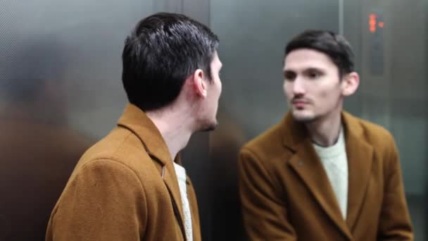 Young Handsome Caucasian Brunette Man Brown Coat Looking Mirror Rises — Vídeos de Stock