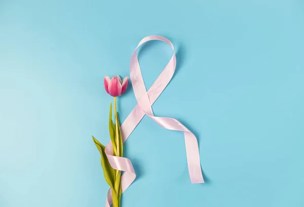 Pink Ribbon Emblem Tulip Lie Center Blue Background Copy Space — Stock Photo, Image