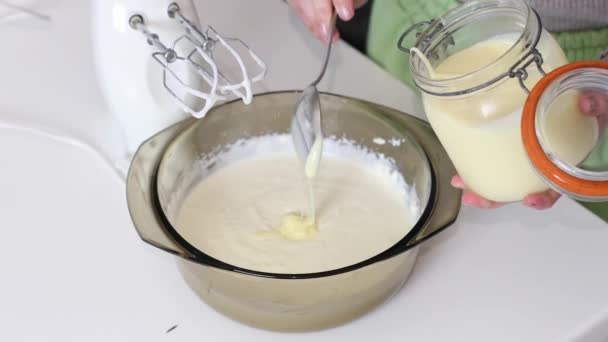 Young Caucasian Unrecognizable Girl Pours Condensed Milk Glass Bowl Whipped — Stock Video