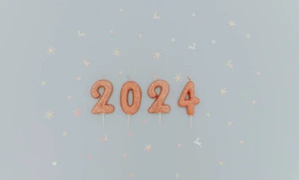 Shiny light brown candles number 2024 lie with white shiny festive confetti lie in the center on a pastel blue background with copy space on the sides, flat lay close-up.