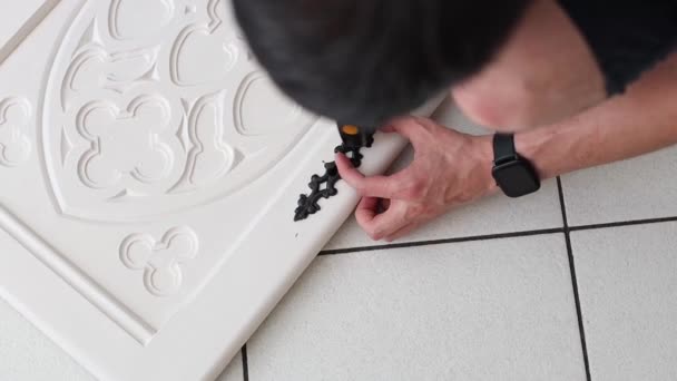 One Young Caucasian Man Hammers Nail Installing Black Carved Vintage — Stock Video