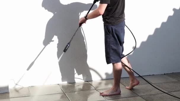 One Young Handsome Brunette Caucasian Man Rinses Tiles Strong Pressure — Stock Video