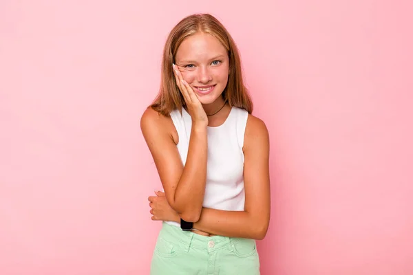 stock image Caucasian teen girl isolated on pink background laughs happily and has fun keeping hands on stomach.