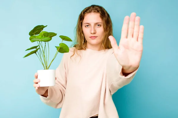 Young Caucasian Woman Holding Plant Isolated Blue Background Standing Outstretched — Stock Photo, Image