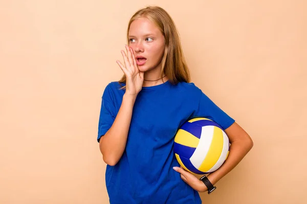 Little Caucasian Girl Playing Volleyball Isolated Beige Background Shouting Holding — Stock Photo, Image
