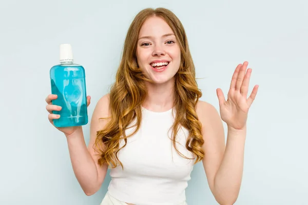 Young Caucasian Woman Holding Mouthwash Isolated Blue Background Receiving Pleasant — Stock Photo, Image