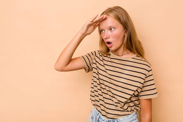 stock image Caucasian teen girl isolated on beige background looking far away keeping hand on forehead.