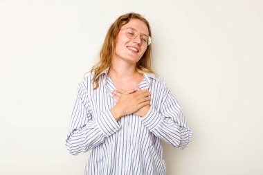 Beyaz arka planda izole edilmiş beyaz tenli genç bir kadın, dostane bir ifadeye sahip, avuçlarını göğsüne bastırıyor. Aşk konsepti.