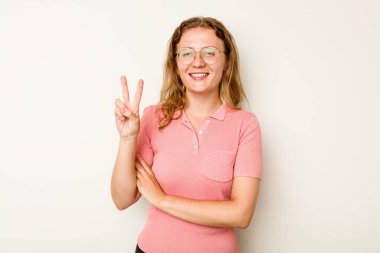 Beyaz arka planda izole edilmiş genç beyaz kadın iki numarayı parmaklarıyla gösteriyor..