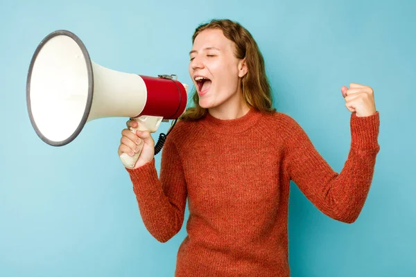 Young Caucasian Woman Holding Megaphone Isolated Blue Background Raising Fist — Stock Photo, Image