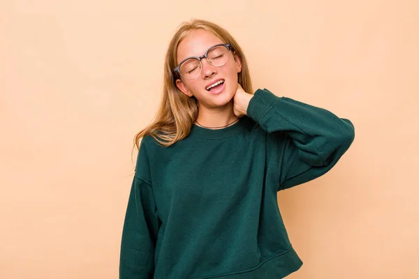 stock image Caucasian teen girl isolated on beige background having a neck pain due to stress, massaging and touching it with hand.