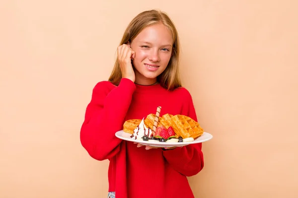 Little Caucasian Girl Holding Waffles Isolated Beige Background Covering Ears — Stock Photo, Image