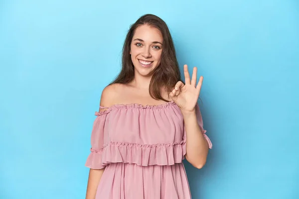Young Woman Wearing Pink Dress Blue Studio Backdrop Cheerful Confident — Stock Photo, Image