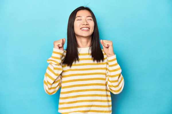 Asiatisk Kvinde Stribet Gul Sweater Fejrer Sejr Lidenskab Entusiasme Glad - Stock-foto