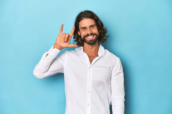 Bearded Man White Shirt Blue Backdrop Showing Horns Gesture Revolution — Stock Photo, Image