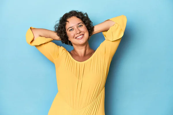 Young Caucasian woman with short hair stretching arms, relaxed position.