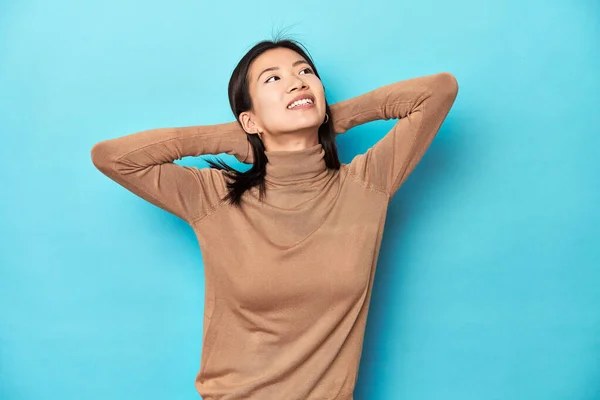 Young Asian Woman Brown Turtleneck Stretching Arms Relaxed Position — Stock Photo, Image