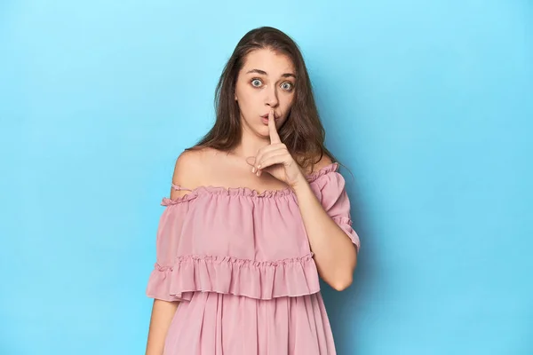 Young Woman Wearing Pink Dress Blue Studio Backdrop Keeping Secret — Stock Photo, Image