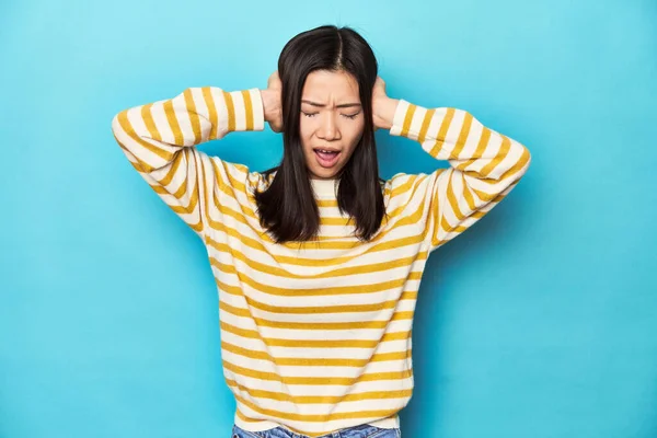 Asian Woman Striped Yellow Sweater Covering Ears Hands Trying Hear — Stock Photo, Image