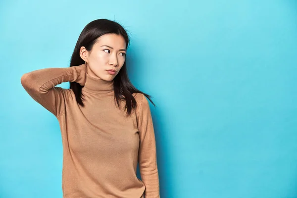 Young Asian Woman Brown Turtleneck Touching Back Head Thinking Making — Stock Photo, Image