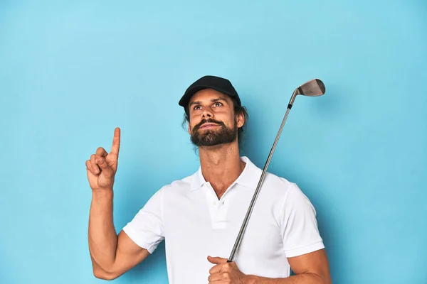 stock image Long-haired golfer with club and hat pointing upside with opened mouth.