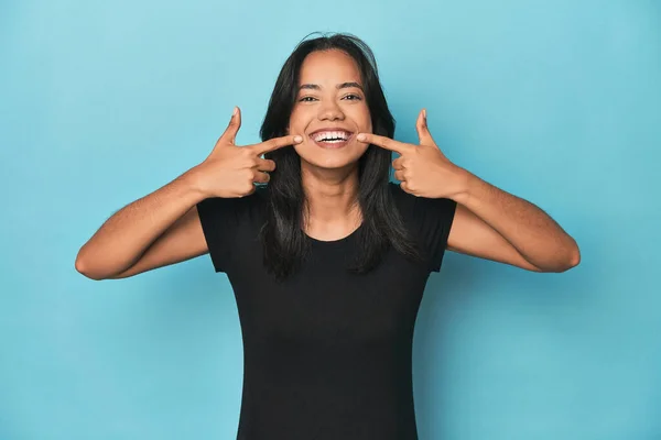 Filipina Young Woman Blue Studio Smiles Pointing Fingers Mouth — Stock Photo, Image