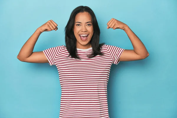 Filipina Young Woman Blue Studio Showing Strength Gesture Arms Symbol — Stock Photo, Image