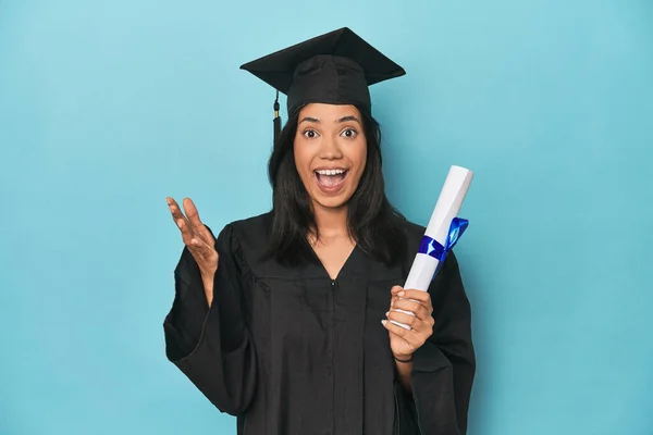 Filipina Graduate Diploma Blue Studio Receiving Pleasant Surprise Excited Raising — Stock Photo, Image