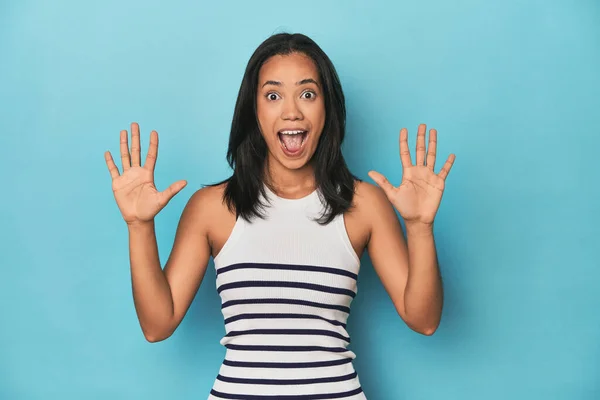 Filipina Young Woman Blue Studio Receiving Pleasant Surprise Excited Raising — Stock Photo, Image