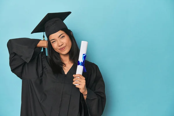 Filipina Graduate Diploma Blue Studio Touching Back Head Thinking Making — Stock Photo, Image