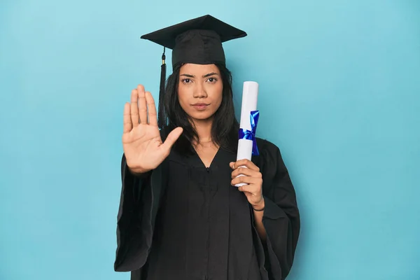 Filipina Graduate Diploma Blue Studio Standing Outstretched Hand Showing Stop — Stock Photo, Image