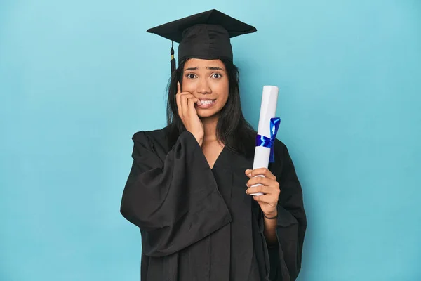 Filipina Graduate Diploma Blue Studio Biting Fingernails Nervous Very Anxious — Stock Photo, Image