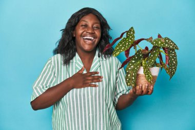 Stüdyoda çiçek tutan kıvrımlı bahçıvan elini göğsüne koyduğunda kahkahalar atıyor..