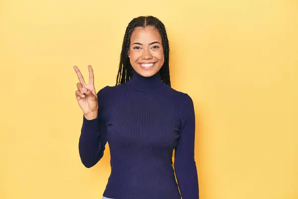 Young Indonesian Woman Yellow Studio Backdrop Joyful Carefree Showing Peace — Stock Photo, Image