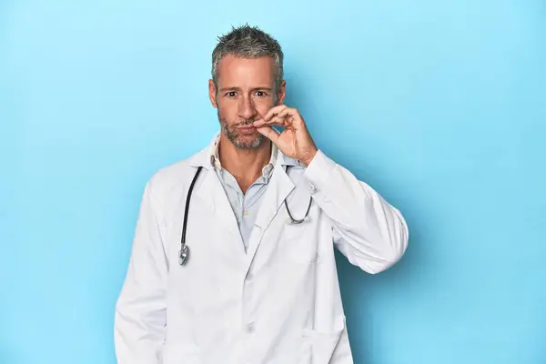 Caucasian Middle Aged Doctor Blue Background Fingers Lips Keeping Secret — Stock Photo, Image