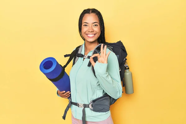 インドネシアの女性は 黄色い陽気で自信を持って良いジェスチャーを示すマウンテン旅行の準備ができています — ストック写真