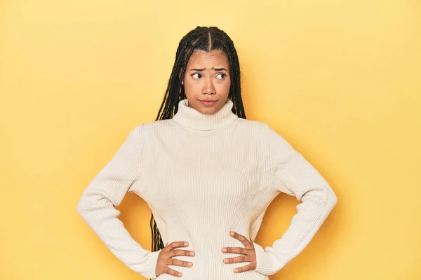 Young Indonesian Woman Yellow Studio Backdrop Confused Feels Doubtful Unsure — Stock Photo, Image
