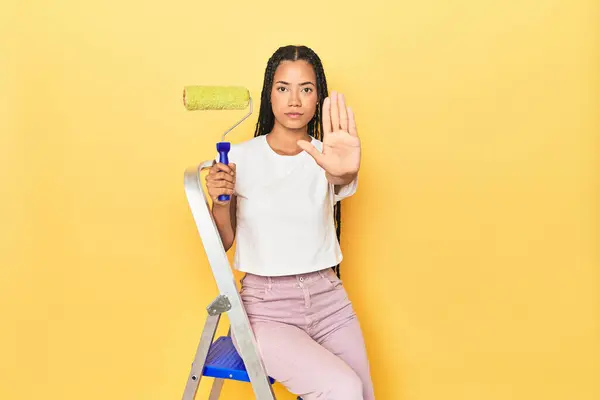 Indonesian Woman Roller Ladder Yellow Standing Outstretched Hand Showing Stop — Stock Photo, Image