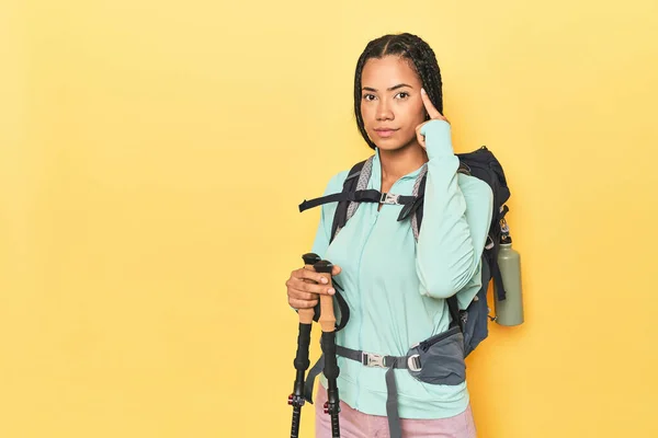 Indonesian Woman Hiking Gear Yellow Pointing Temple Finger Thinking Focused — Stock Photo, Image