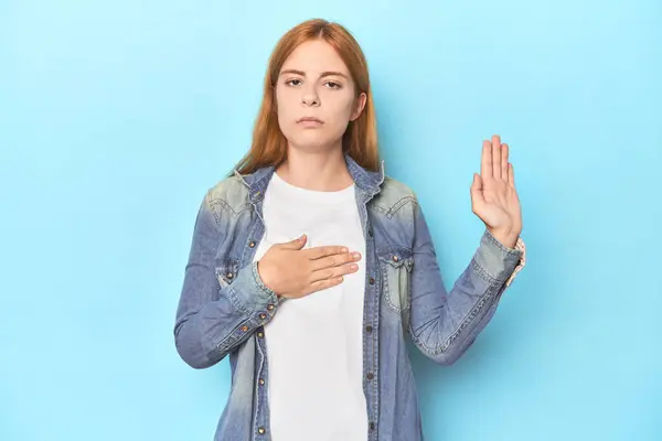 Redhead Young Woman Blue Background Taking Oath Putting Hand Chest — Stock Photo, Image