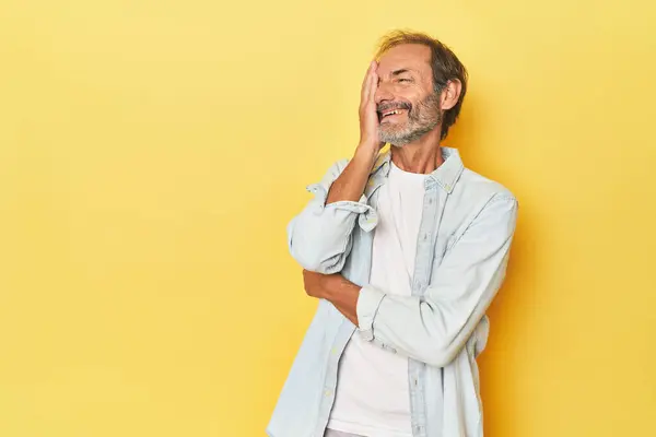 Caucasian Middle Aged Man Yellow Studio Laughing Happy Carefree Natural — Stock Photo, Image