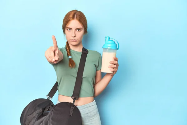 Redhead Holding Protein Shake Blue Studio Showing Number One Finger — Stock Photo, Image