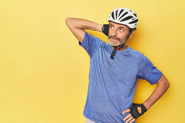 Cyclist Wearing Helmet Yellow Studio Touching Back Head Thinking Making — Stock Photo, Image