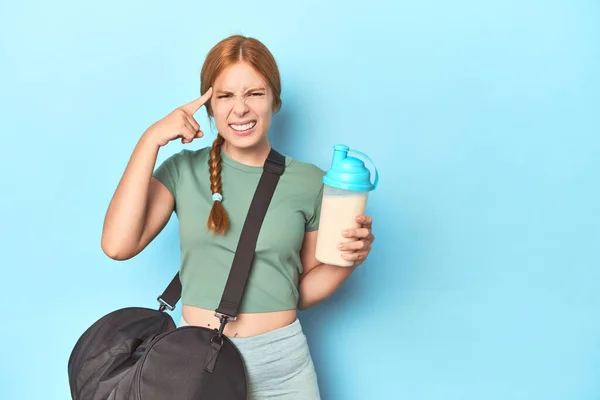 Redhead Holding Protein Shake Blue Studio Showing Disappointment Gesture Forefinger — Stock Photo, Image