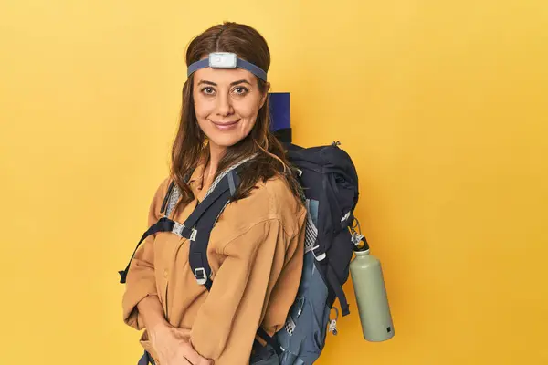 Portrait Beautiful Adult Woman Hiking Backpack Head Lamp Yellow Background — Stock Photo, Image