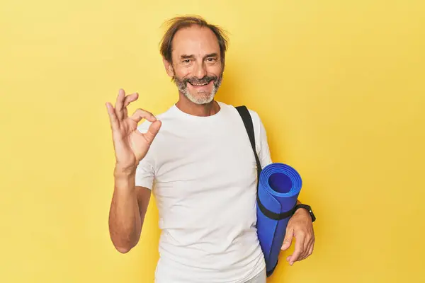 Man Yoga Mat Yellow Studio Cheerful Confident Showing Gesture — Stock Photo, Image